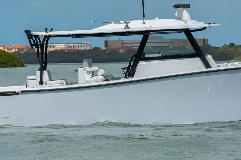  Yacht Photos Pics 2024 Yellowfin 42 Offshore boat cruising on calm waters, showcasing sleek design and modern features.