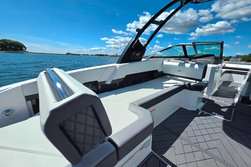  Yacht Photos Pics 2024 Cobalt R8 Outboard boat interior with sleek seating, on a sunny day by the water.
