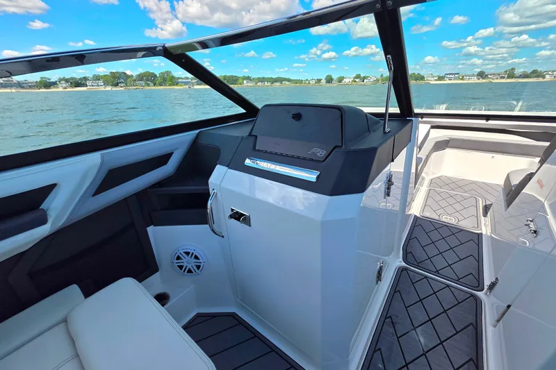  Yacht Photos Pics 2024 Cobalt R8 Outboard boat interior with sleek design and modern dashboard on a sunny day.