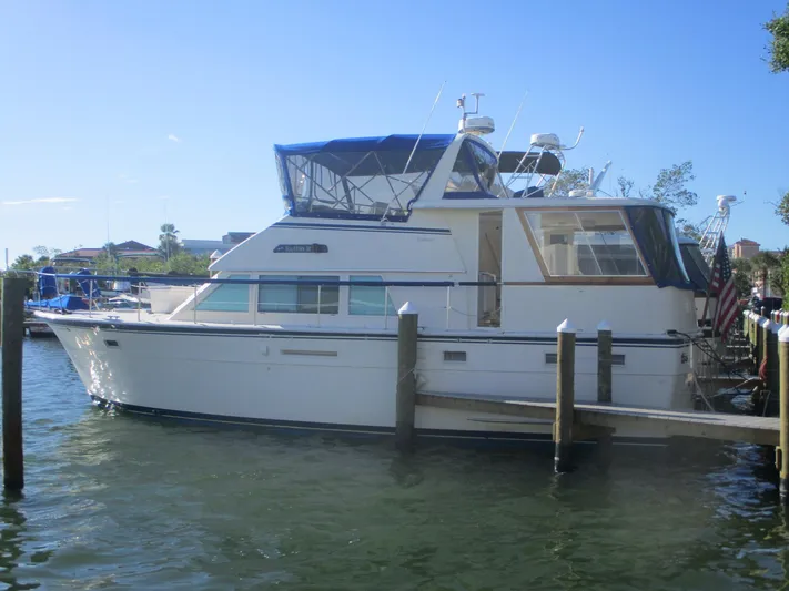  Yacht Photos Pics 1986 Hatteras 43 Double Cabin yacht docked in a marina under clear blue sky.