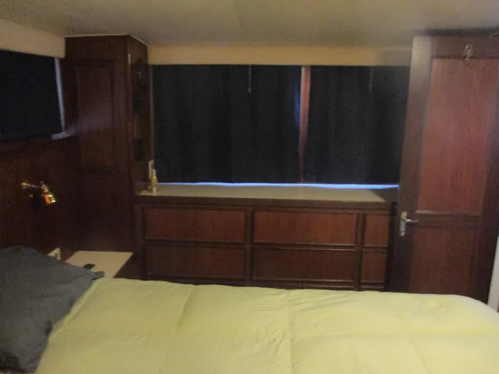  Yacht Photos Pics Interior of 1986 Hatteras 43 Double Cabin with wood paneling and bed.