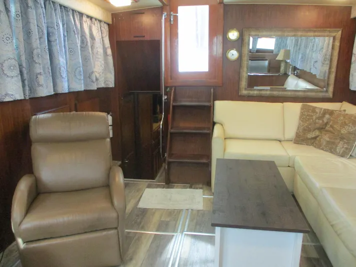  Yacht Photos Pics Interior of 1986 Hatteras 43 Double Cabin with beige seating and wooden accents.