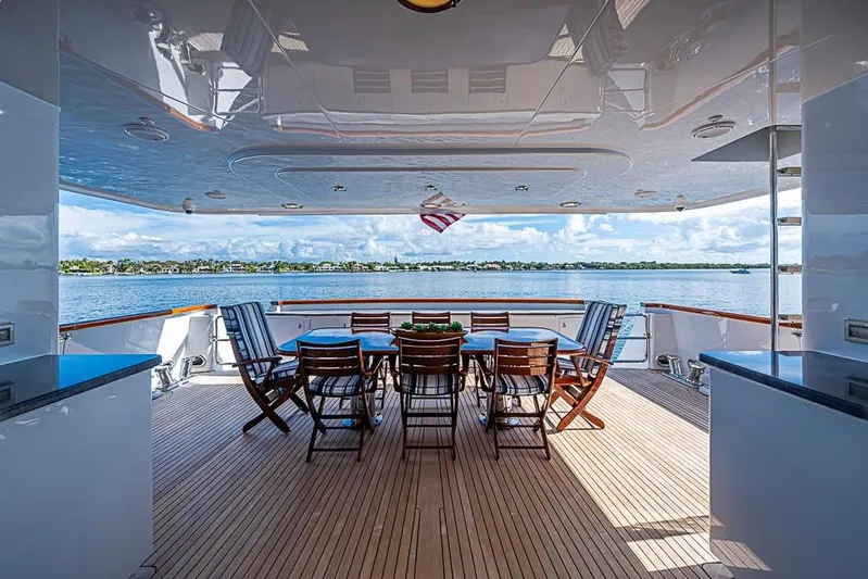 Probability Yacht Photos Pics Luxurious 1997 Delta Marine yacht deck with dining area overlooking serene waters.