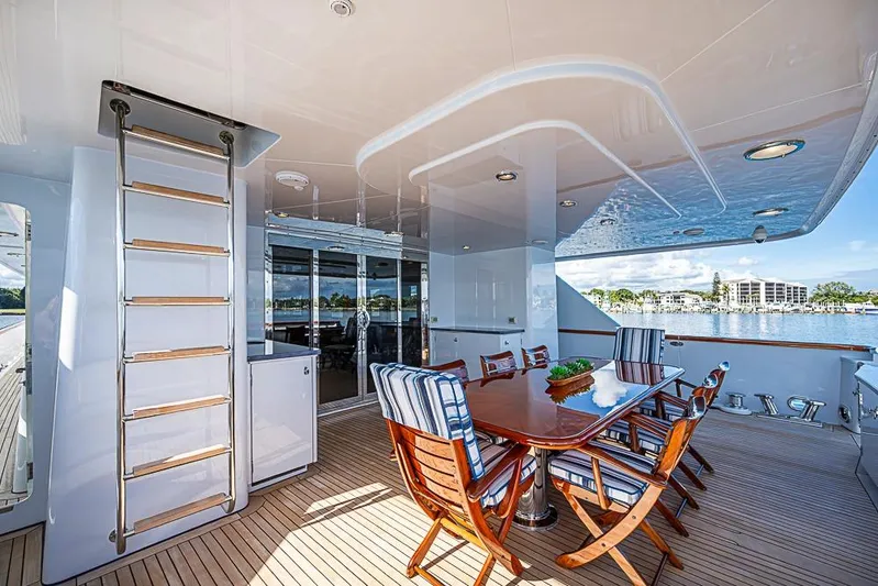Probability Yacht Photos Pics Luxurious 1997 Delta Marine yacht deck with dining area and scenic waterfront view.