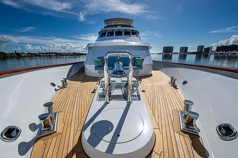 Probability Yacht Photos Pics Luxury Delta Marine yacht deck, 1997 model, with polished wood and chrome details under a clear blue sky.