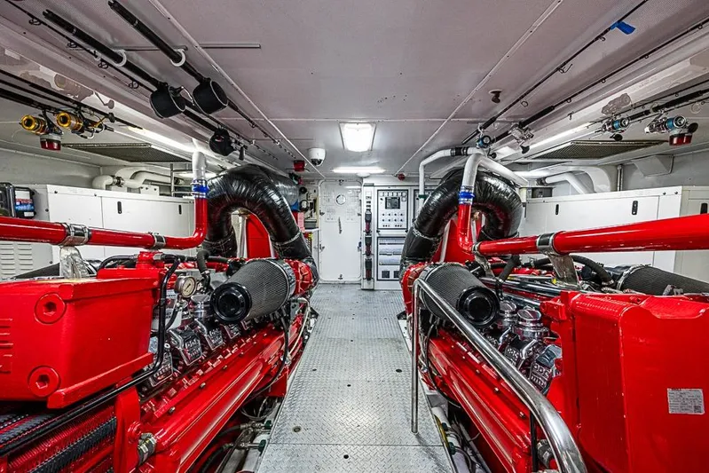 Probability Yacht Photos Pics Engine room of a 1997 Delta Marine vessel with red machinery and control panels.