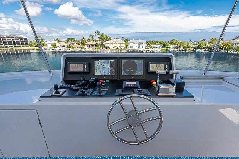 Probability Yacht Photos Pics Control panel of a 1997 Delta Marine yacht with navigation screens and steering wheel.