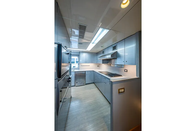 Probability Yacht Photos Pics Modern yacht kitchen with sleek cabinetry, stainless steel appliances, and bright lighting, Delta Marine 1997.