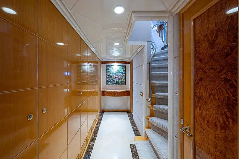 Probability Yacht Photos Pics Luxurious yacht interior hallway with wooden paneling, artwork, and carpeted stairs, Delta Marine 1997.