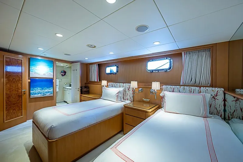 Probability Yacht Photos Pics Luxurious 1997 Delta Marine yacht cabin with twin beds, elegant decor, and ocean-themed artwork.