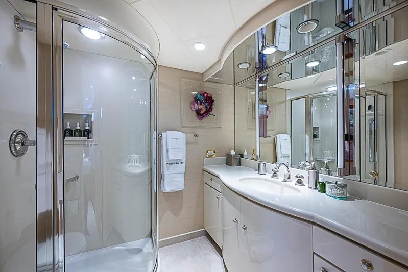 Probability Yacht Photos Pics Luxurious yacht bathroom with curved shower, elegant vanity, and mirrored cabinets, Delta Marine 1997.