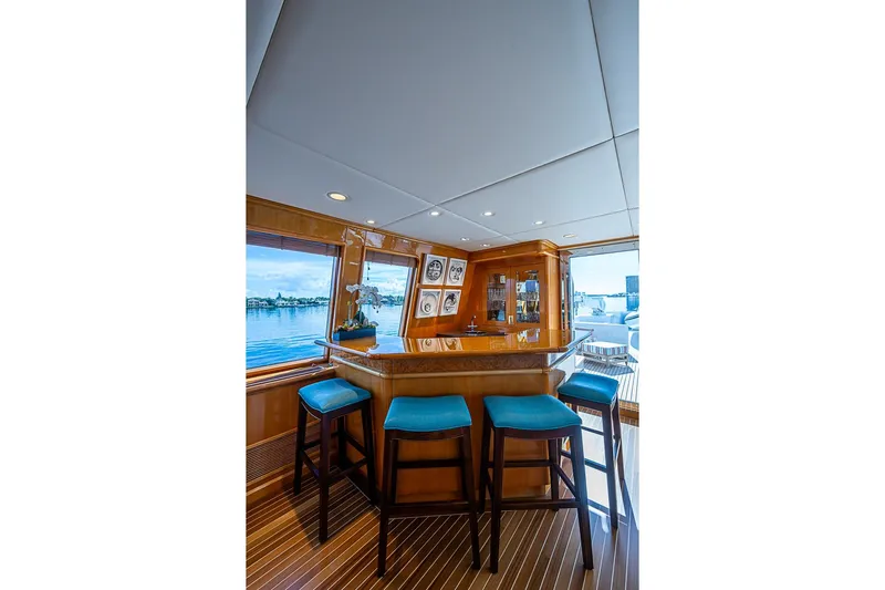 Probability Yacht Photos Pics Luxurious yacht interior with bar stools, wooden finishes, and ocean view, Delta Marine 1997.