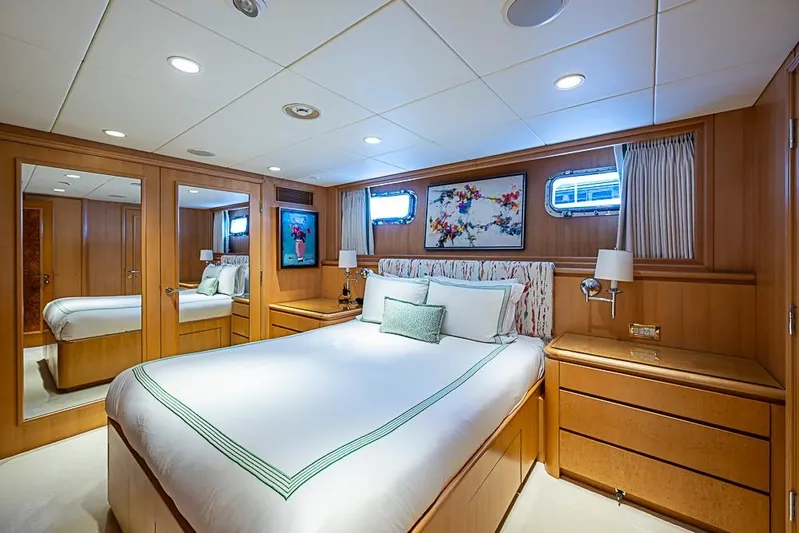 Probability Yacht Photos Pics Luxurious bedroom interior on 1997 Delta Marine yacht, featuring elegant wood paneling and modern decor.