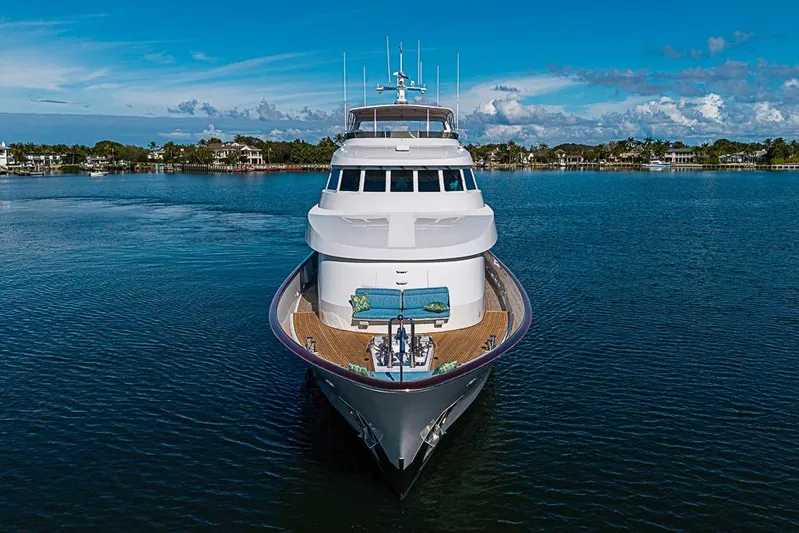 Probability Yacht Photos Pics Luxurious 1997 Delta Marine yacht on serene water under a clear blue sky.