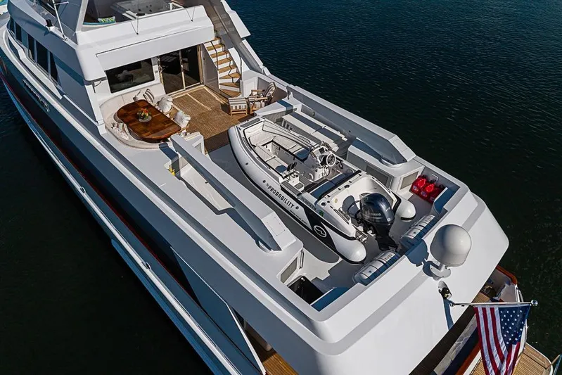 Probability Yacht Photos Pics Luxurious 1997 Delta Marine yacht with spacious deck and tender boat, flying American flag.