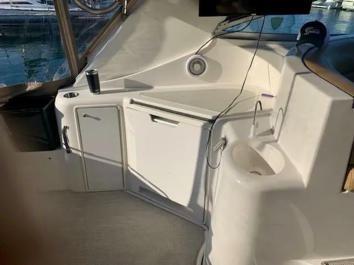  Yacht Photos Pics 1998 Cruisers Yachts 3870 Express interior with kitchenette and sink, featuring modern amenities.