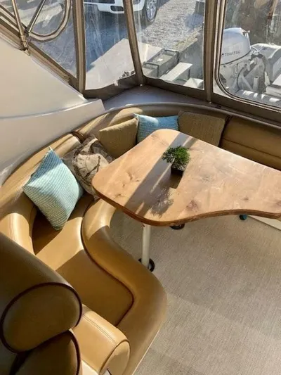  Yacht Photos Pics Interior of 1998 Cruisers Yachts 3870 Express with elegant seating and wooden table.