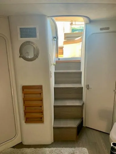  Yacht Photos Pics 1998 Cruisers Yachts 3870 Express interior stairs with modern design and wooden accents.