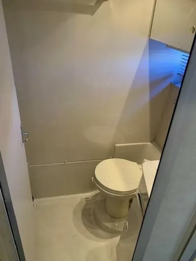  Yacht Photos Pics 1998 Cruisers Yachts 3870 Express bathroom interior with toilet and storage.