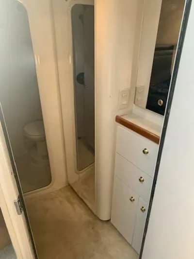  Yacht Photos Pics Bathroom interior of 1998 Cruisers Yachts 3870 Express with shower and storage cabinets.