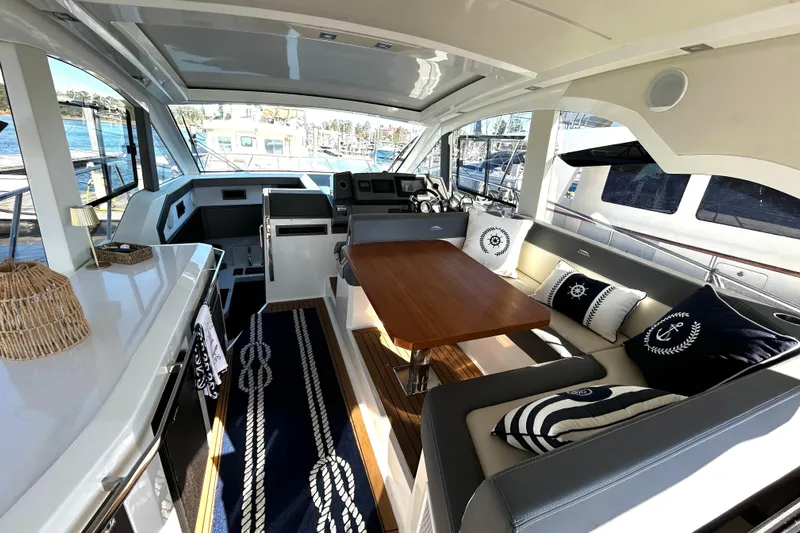 Zantical Yacht Photos Pics Luxurious interior of 2020 Galeon 425 HTS yacht with elegant seating and nautical decor.
