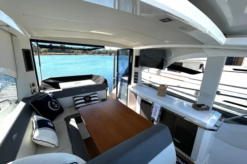 Zantical Yacht Photos Pics Luxurious interior of 2020 Galeon 425 HTS yacht with elegant seating and scenic water view.