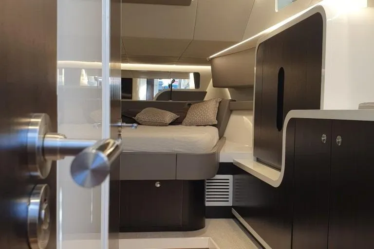 Malola Yacht Photos Pics Luxurious interior cabin of 2022 Canados Gladiator 431 WA yacht, featuring modern design and cozy bedding.