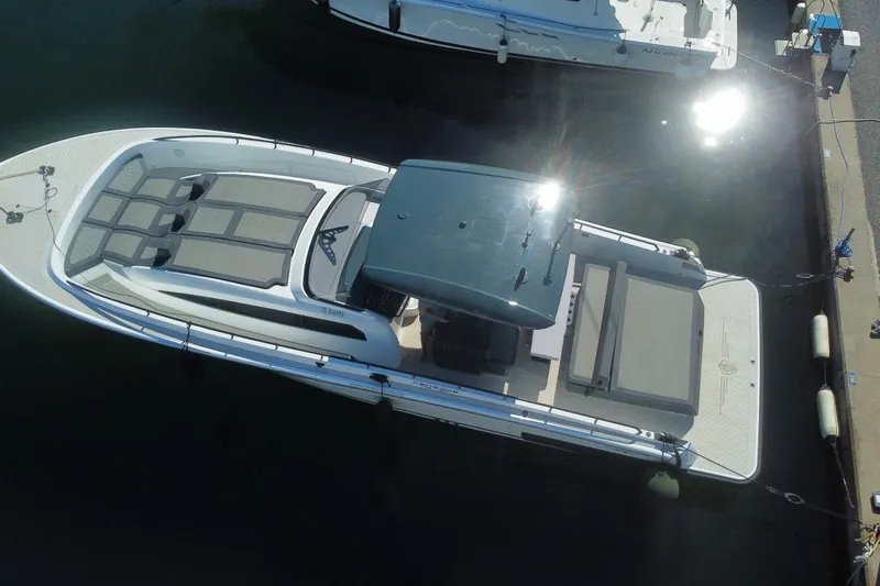 Malola Yacht Photos Pics Aerial view of 2022 Canados Gladiator 431 WA luxury yacht docked in sunlight.
