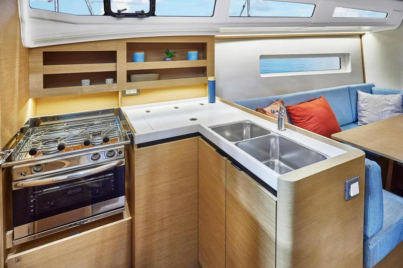  Yacht Photos Pics Modern kitchen interior of 2022 Jeanneau Sun Odyssey 380 yacht with stove and sink.