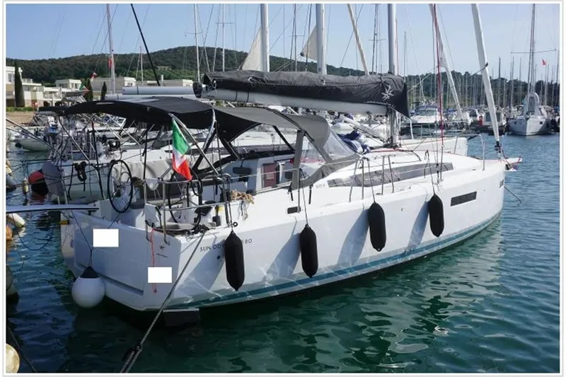  Yacht Photos Pics 2022 Jeanneau Sun Odyssey 380 sailboat docked in marina, featuring sleek design and modern amenities.
