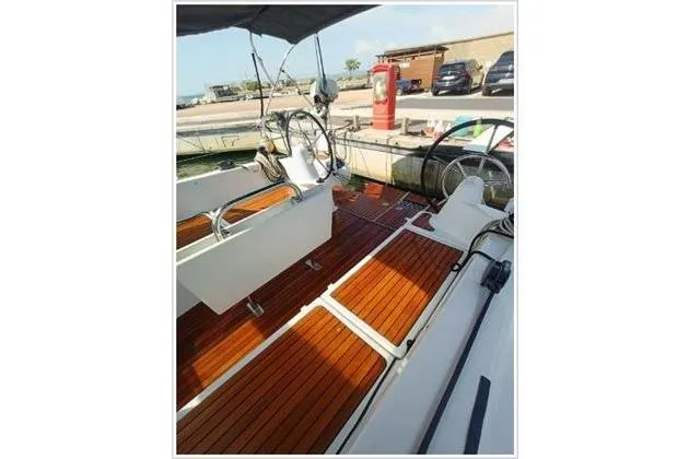  Yacht Photos Pics 2022 Jeanneau Sun Odyssey 380 sailboat with teak deck and dual steering wheels.
