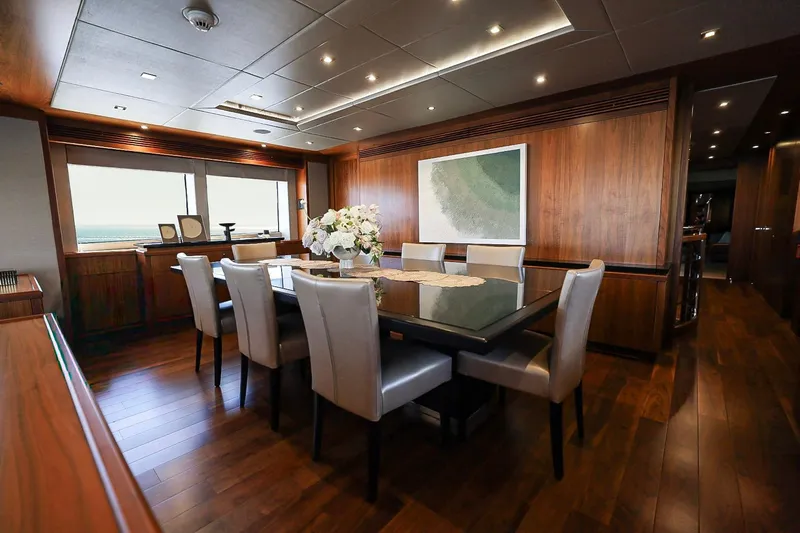 Marin Yacht Photos Pics Luxurious dining area on 2014 Sunseeker 131 yacht with elegant decor and wood paneling.