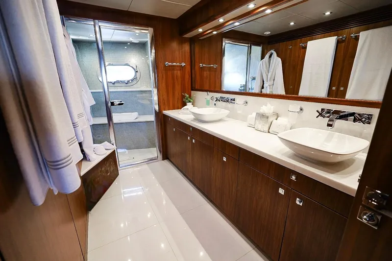 Marin Yacht Photos Pics Luxurious bathroom on 2014 Sunseeker 131 yacht with dual sinks and elegant wood finishes.