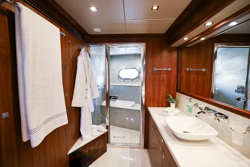 Marin Yacht Photos Pics Luxurious bathroom on 2014 Sunseeker 131 yacht with elegant wood paneling and modern fixtures.