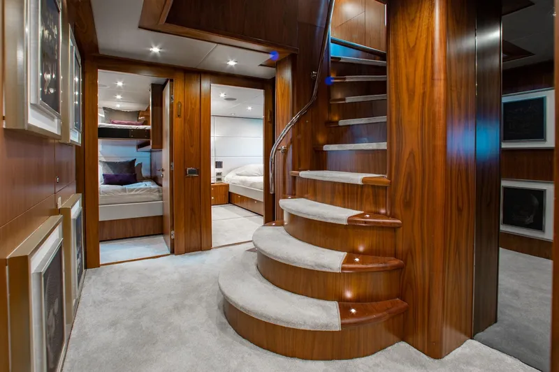 Marin Yacht Photos Pics Luxurious interior of 2014 Sunseeker 131 yacht with elegant wooden staircase and cozy bedrooms.