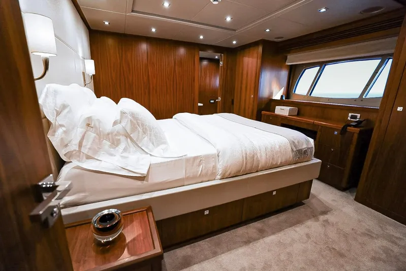 Marin Yacht Photos Pics Luxurious bedroom interior of 2014 Sunseeker 131 yacht with elegant wood paneling.