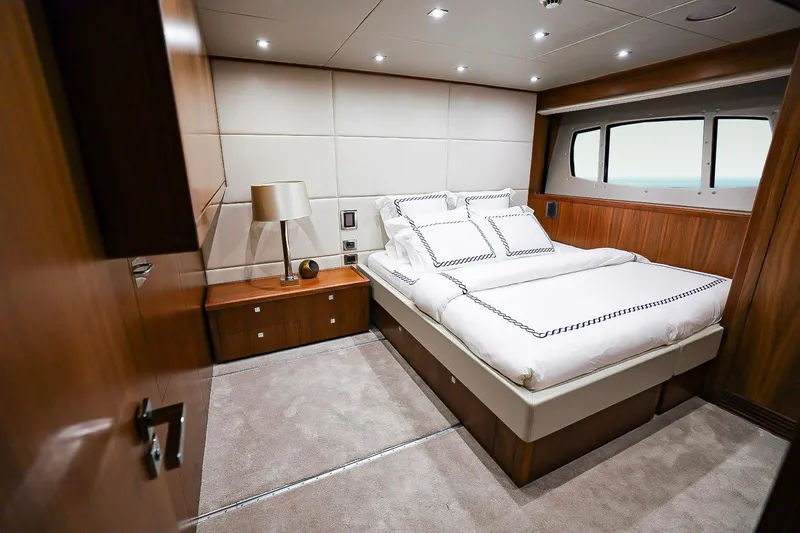 Marin Yacht Photos Pics Luxurious bedroom interior on 2014 Sunseeker 131 yacht with elegant wood finishes.