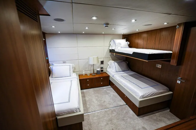 Marin Yacht Photos Pics Luxurious cabin interior of 2014 Sunseeker 131 yacht with three beds and elegant wood finish.