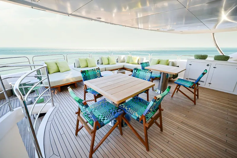 Marin Yacht Photos Pics Luxurious Sunseeker 131 yacht deck with seating, tables, and ocean view, 2014 model.
