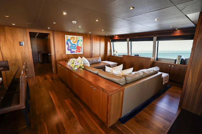 Marin Yacht Photos Pics Luxurious interior of 2014 Sunseeker 131 yacht with elegant wood paneling and ocean view.