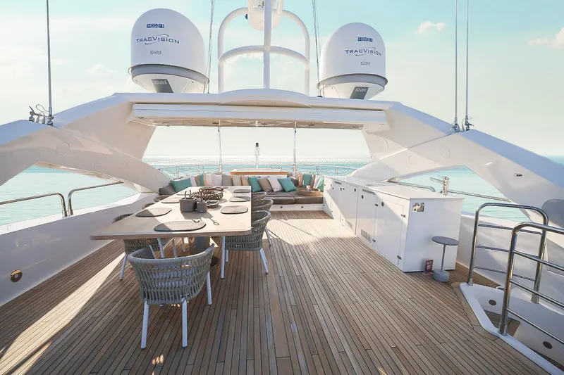 Marin Yacht Photos Pics Luxurious Sunseeker 131 yacht deck with dining area, 2014 model, overlooking serene ocean views.