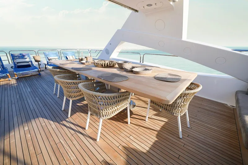 Marin Yacht Photos Pics Luxurious Sunseeker 131 yacht deck with elegant dining setup, wicker chairs, and ocean view.