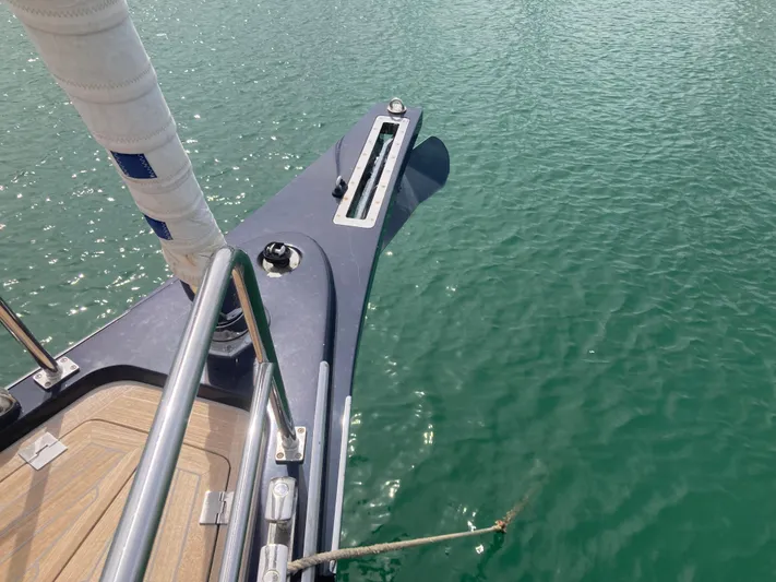  Yacht Photos Pics Bow of a 2022 Solaris 55 yacht on calm green water.