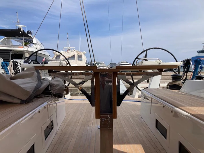  Yacht Photos Pics 2022 Solaris 55 yacht deck with dual steering wheels in a marina setting.