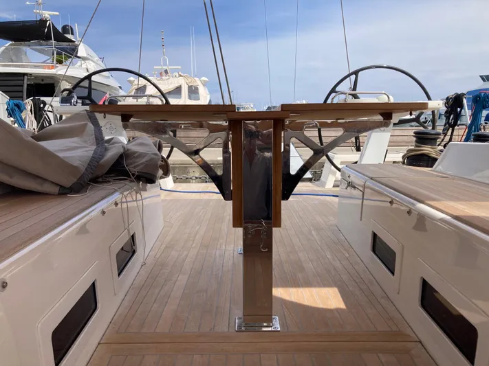  Yacht Photos Pics 2022 Solaris 55 yacht deck with dual steering wheels and wooden flooring.