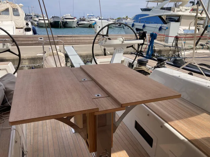  Yacht Photos Pics Cockpit of 2022 Solaris 55 yacht with wooden table and marina view.