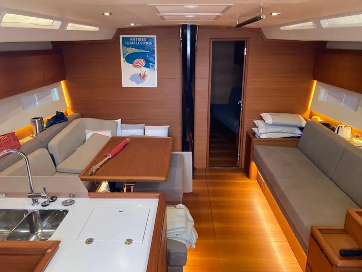  Yacht Photos Pics Luxurious interior of a 2022 Solaris 55 yacht with modern wood finishes and cozy seating.