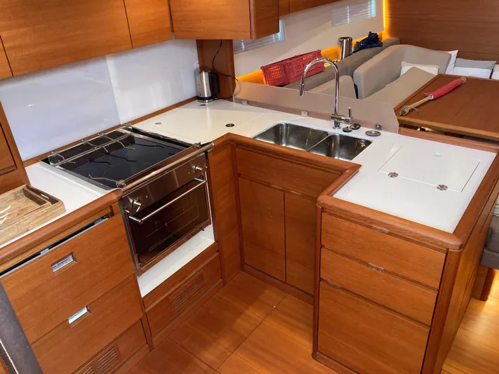  Yacht Photos Pics Luxurious kitchen interior of 2022 Solaris 55 yacht with modern appliances and wooden cabinetry.