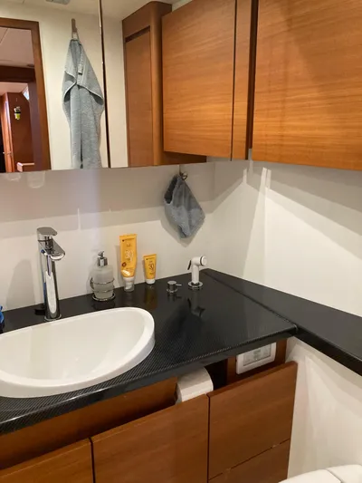  Yacht Photos Pics Modern bathroom in 2022 Solaris 55 yacht with sleek fixtures and wooden cabinetry.