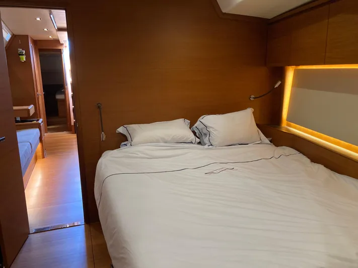 Yacht Photos Pics Luxurious interior cabin of 2022 Solaris 55 yacht with cozy bed and wooden finish.